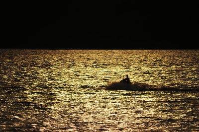 Boat sailing in sea at night