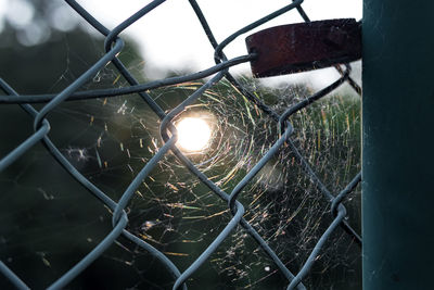 Close-up of chainlink fence against sky