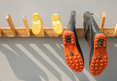 Close-up of shoes hanging on wood