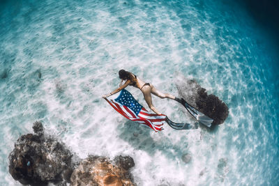 High angle view of woman swimming in sea