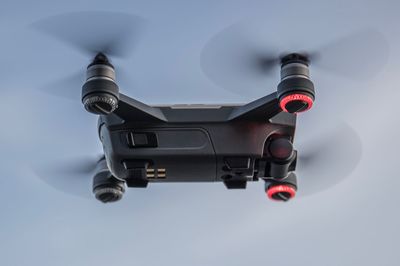 Close-up of quadcopter flying against sky