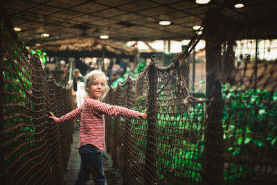 Portrait of cute girl standing on bridge