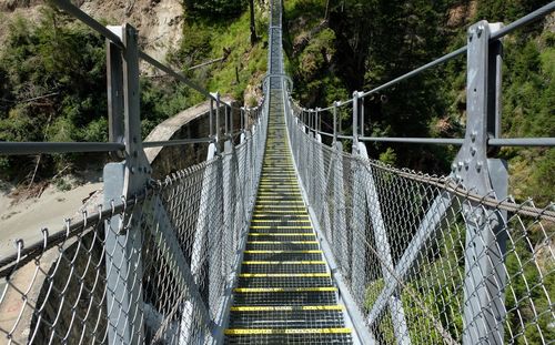 Suspension bridge between the trees in the alps mountains in kals am grossglockner in austria
