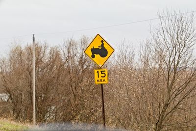 Road sign against sky