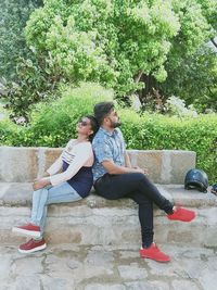 Mother and girl sitting on plant