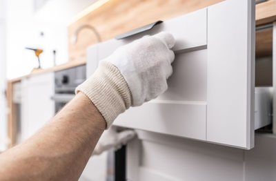 Cropped hand of person opening door