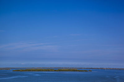 Scenic view of sea against blue sky