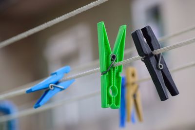 Close-up of clothespins hanging on rope