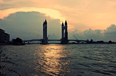 Bridge over sea against buildings in city