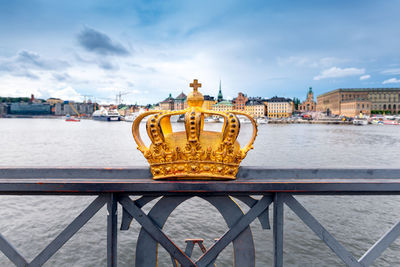 Gilded crown at the middle of skeppsholmen bridge at stockholm, sweden