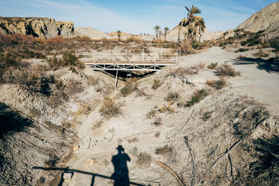 Shadow of person on land in desert