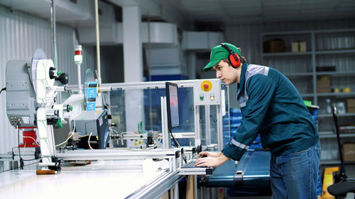 Worker of printing equipment, adjusts, regulates the printing process. working process of printing