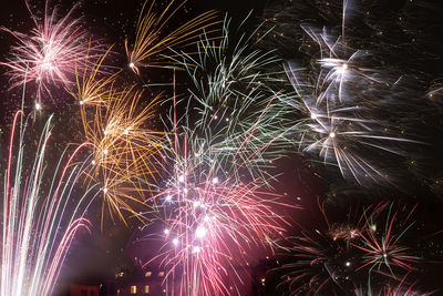 Low angle view of firework display at night