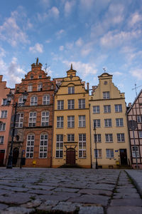 Low angle view of buildings against sky during winter