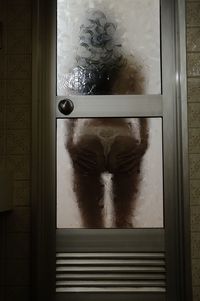 Portrait of person seen through glass window