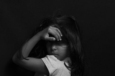 Portrait of girl against black background