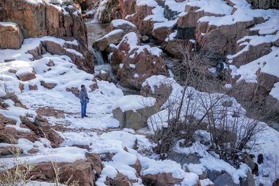 Man standing on snowy rock