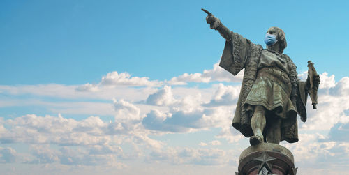 Low angle view of statue against blue sky