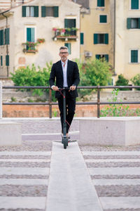 Full length of man with umbrella in city