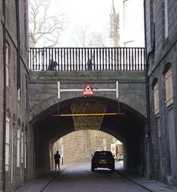 Car on street amidst buildings in city