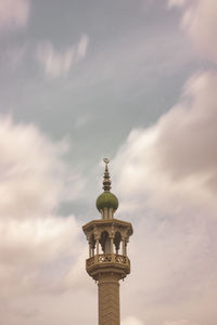 Low angle view of tower against cloudy sky