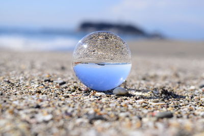 Close-up sea reflecting on circular ball