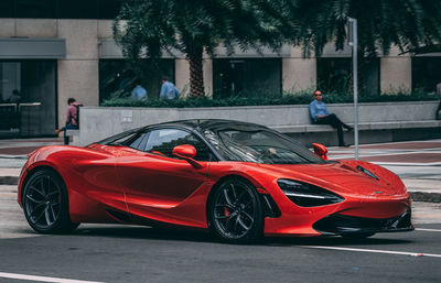 Red car on road in city