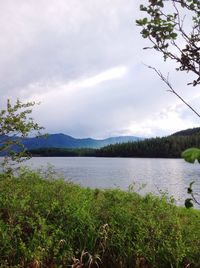 Scenic view of lake against cloudy sky