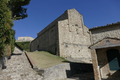 Low angle view of historic building against clear blue sky