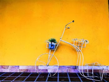Bicycle against yellow wall