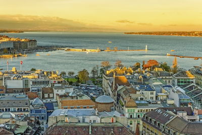 Panorama of geneva city with leman lake by beautiful sunset from cathedral saint-pierre, switzerland