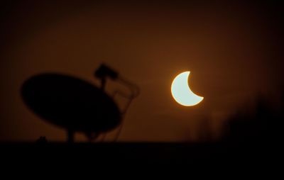 Close-up of silhouette crab against clear sky during sunset