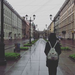 Rear view of woman walking on street in city