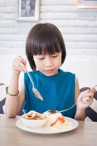 Midsection of boy eating food