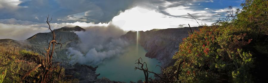 Panoramic view of trees and mountains against sky