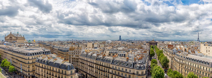 Panoramic high angle view of buildings against cloudy sky