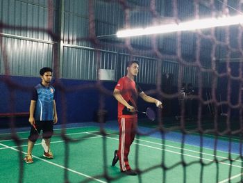 Full length of man standing in illuminated building