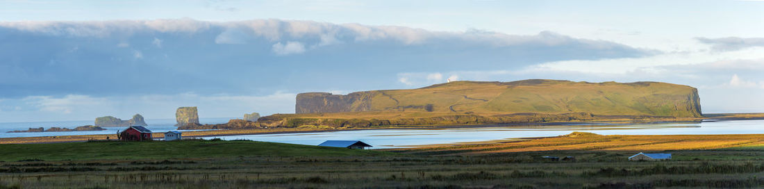 Panoramic view of land and mountains against sky