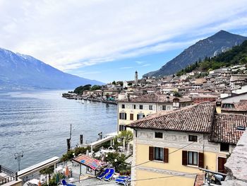 High angle view of townscape by sea against sky