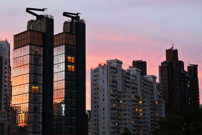 Modern buildings against sky at dusk