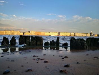 Scenic view of beach against sky during sunset