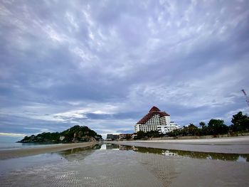 View of beach against cloudy sky