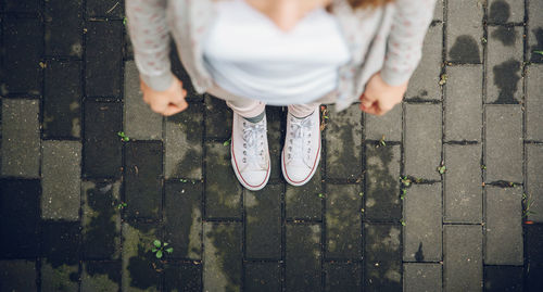 Low section of woman standing on ground