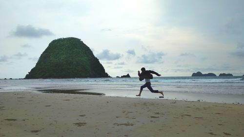 Full length of man on beach against sky