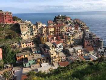 High angle view of townscape by sea against sky