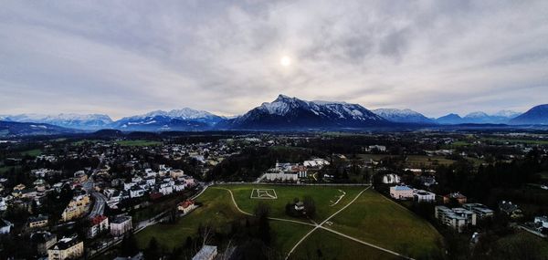 High angle view of townscape and mountains against sky