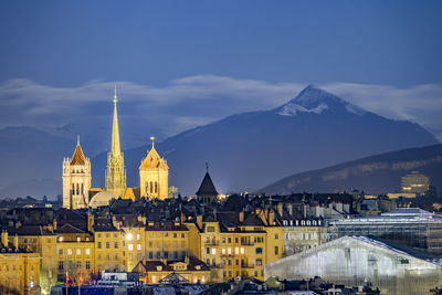 Illuminated st pierre cathedral in town at dusk