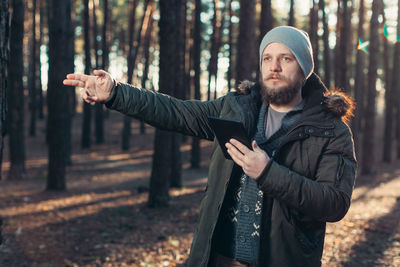 Young man looking away in forest