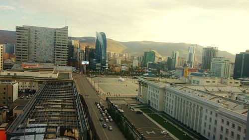 High angle view of street amidst buildings against sky