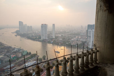 High angle view of river by buildings against sky